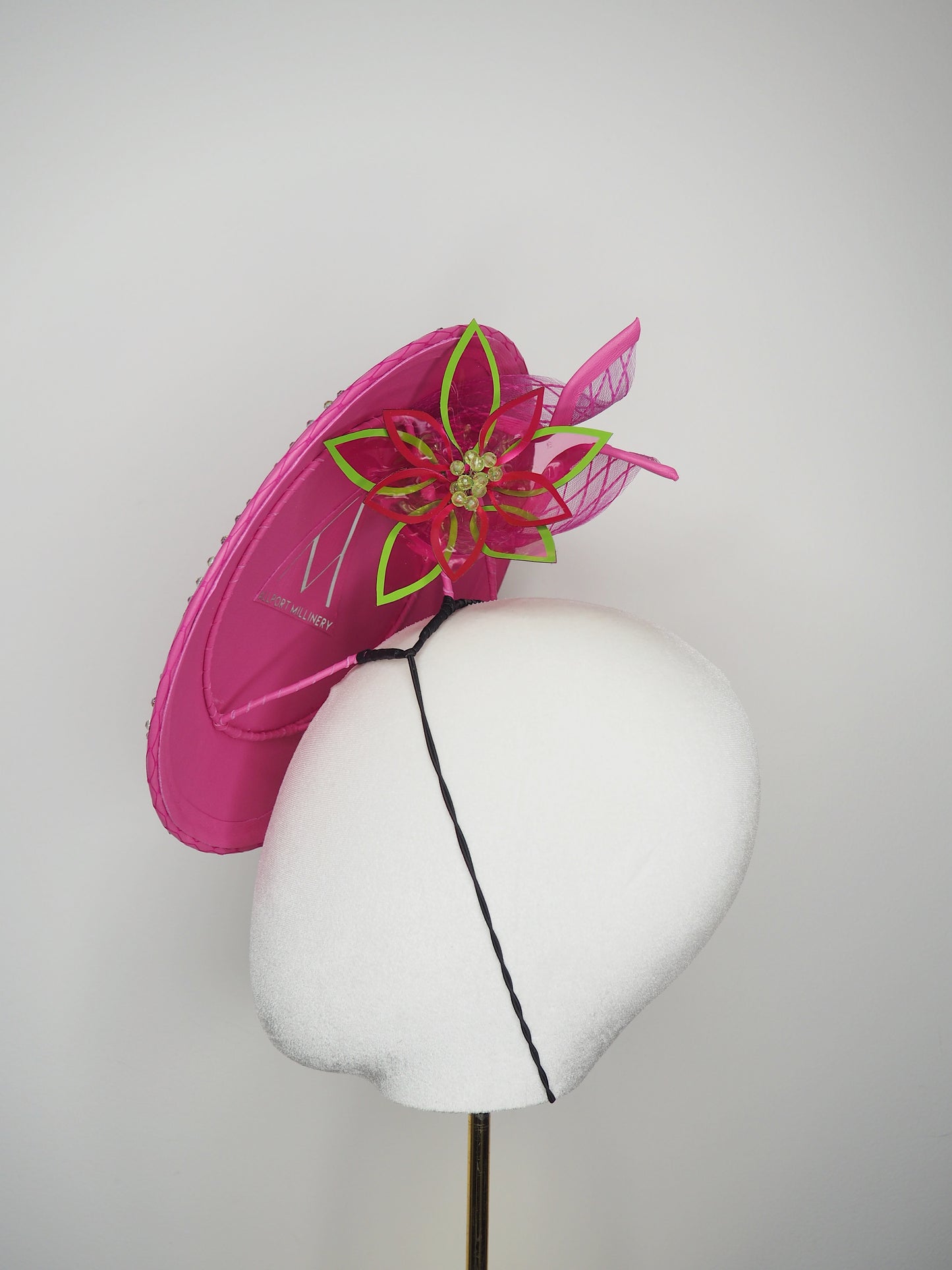 A Little Bit Wicked - Candy pink  crystal encrusted leather disc with flower and wired swirl trim.