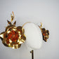 Sunlit Bloom - A wraparound floral headpiece featuring oversized golden blooms with vibrant orange centres.