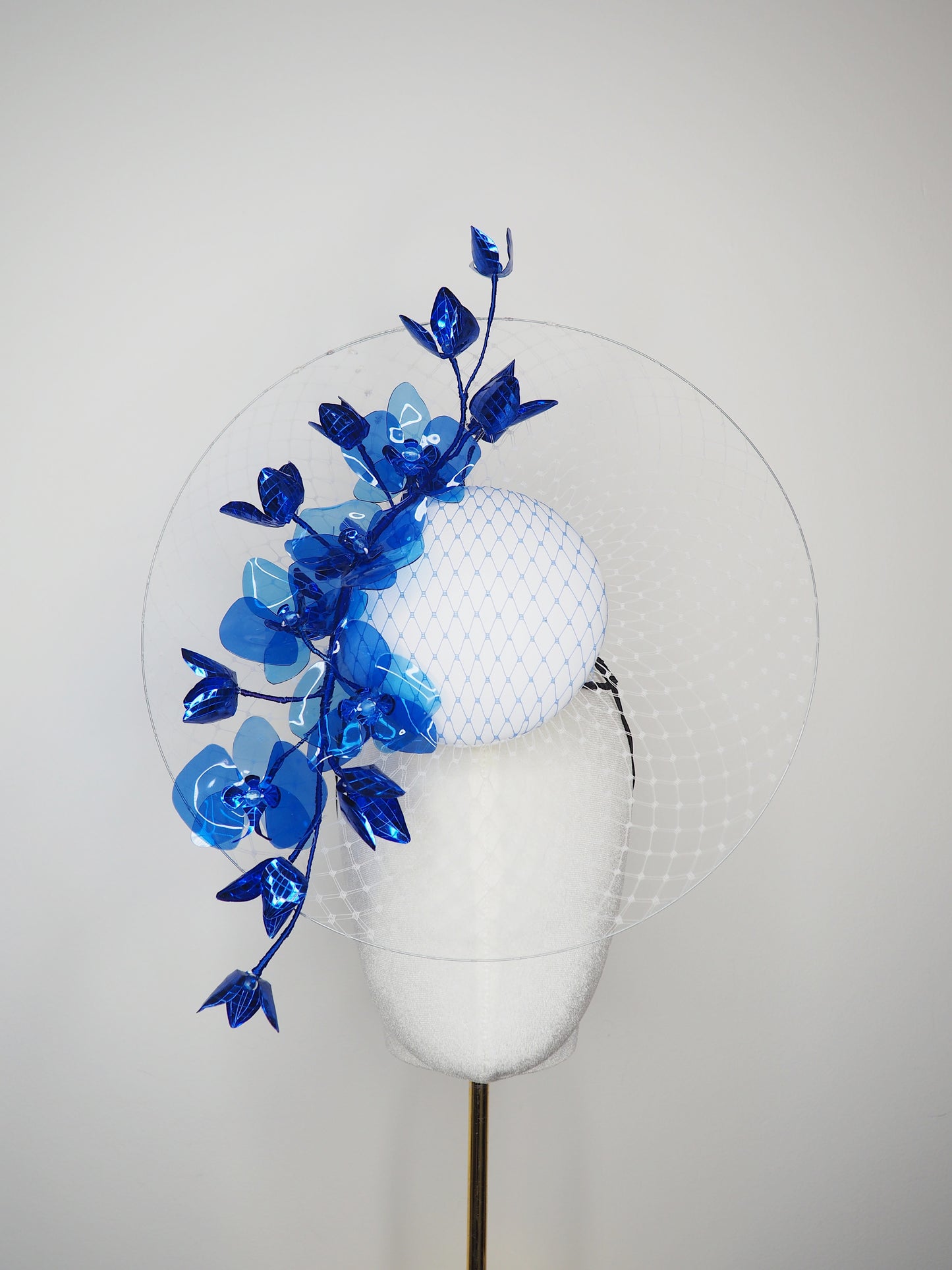 Dancing Orchids - Blue crystoform orchids on a white leather veiles percher base with veil detail