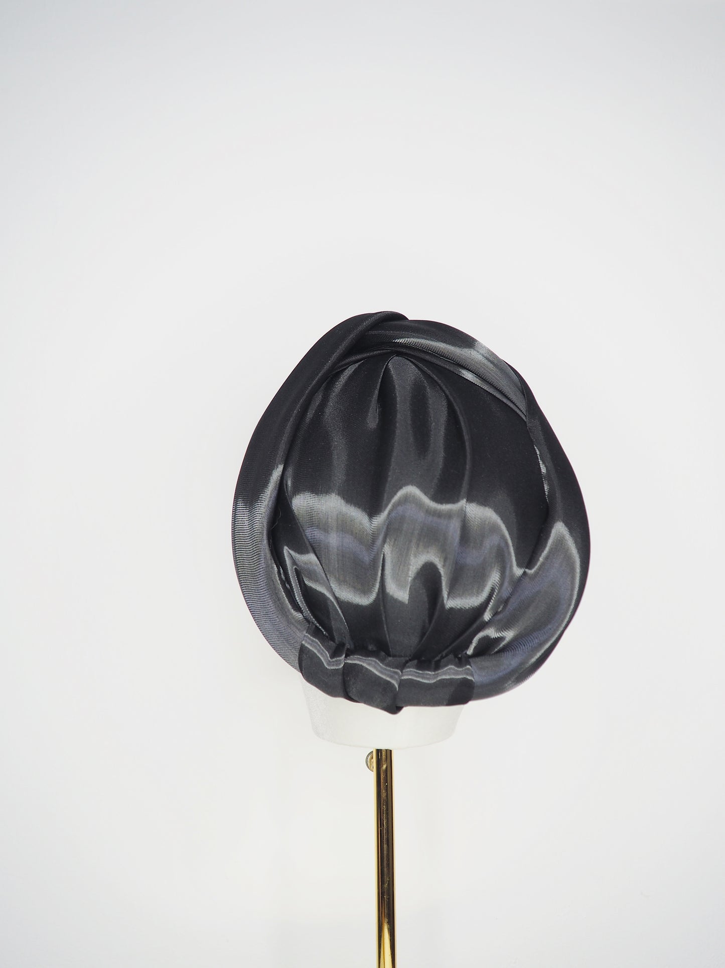 Glass Lake - A sculptural blocked turban crafted from luminous fabric inspired by morning reflections on water.