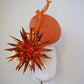 Solar Spark - Round gold and orange percher with orange sequin film starburst and gold quill detail