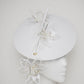 Lys En Blanc - White Crystoform Lillies on a floating leather disk with quill detail.