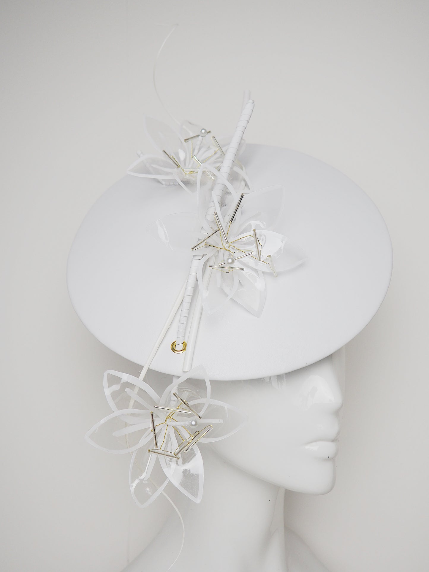 Lys En Blanc - White Crystoform Lillies on a floating leather disk with quill detail.