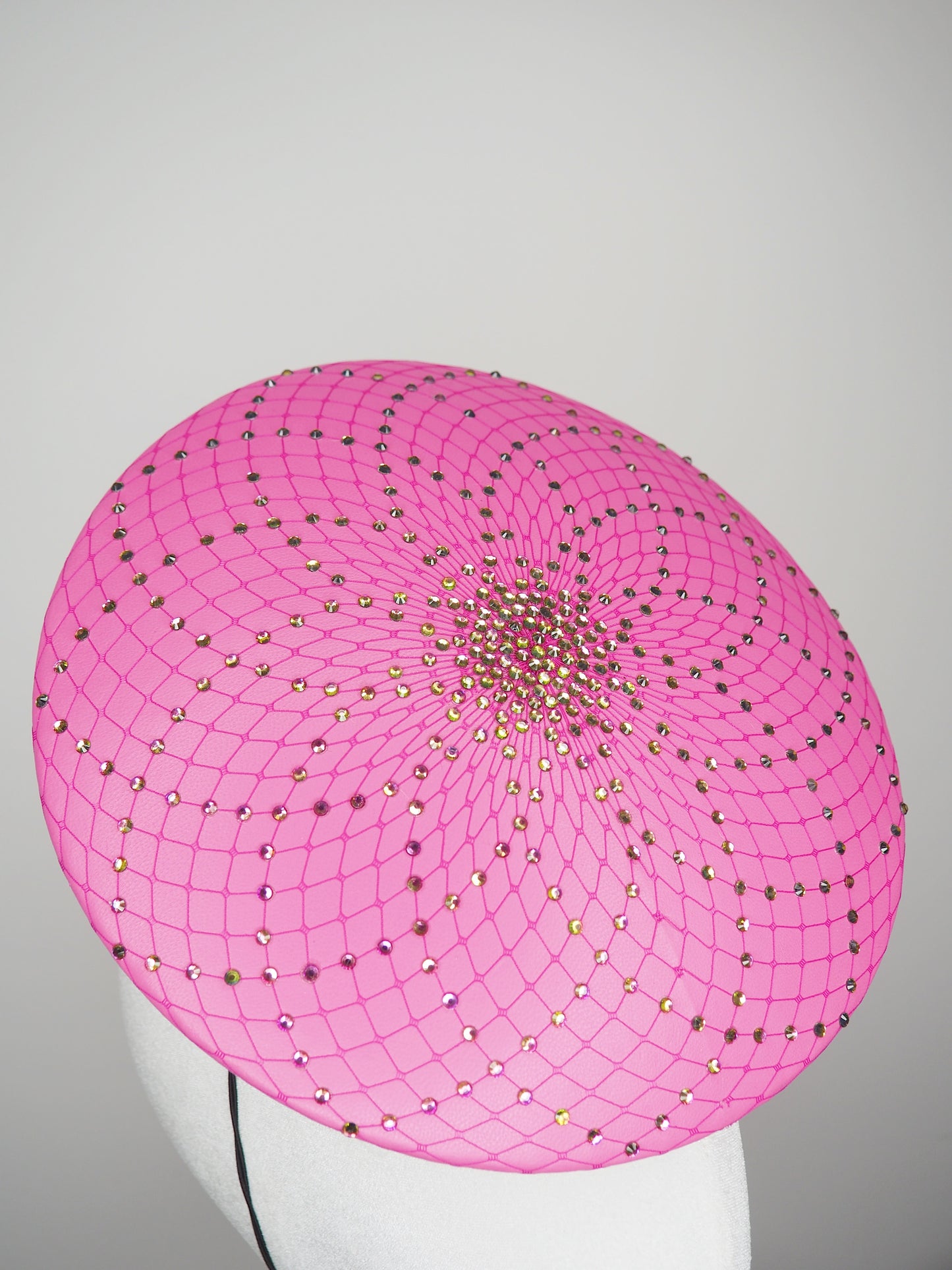 A Little Bit Wicked - Candy pink  crystal encrusted leather disc with flower and wired swirl trim.