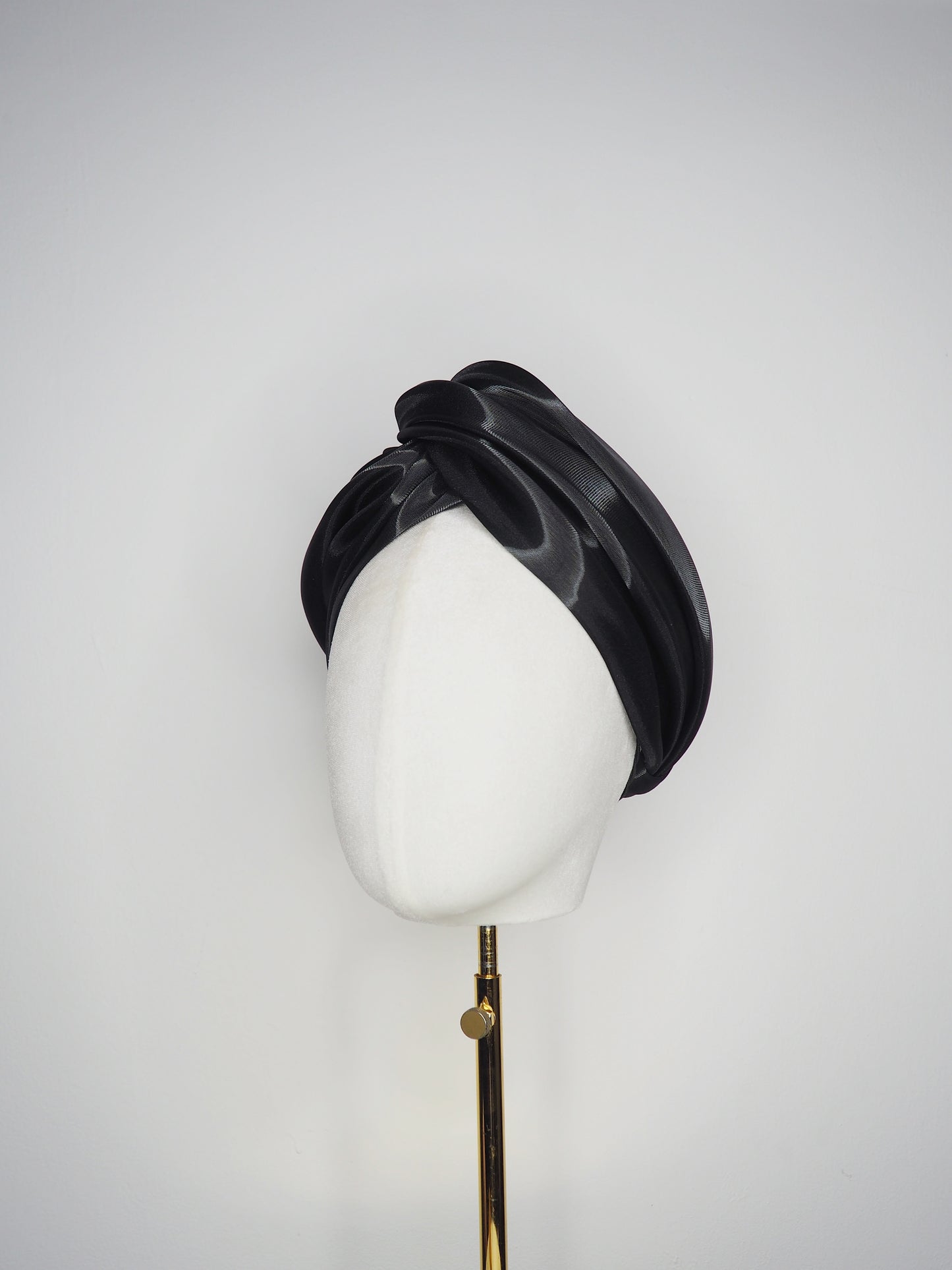 Glass Lake - A sculptural blocked turban crafted from luminous fabric inspired by morning reflections on water.