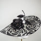 De Ville Rose - Sweeping crystoform wired brim with black rose petal pattern and single shiny dramatic rose with white leather veiled crown