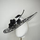 De Ville Rose - Sweeping crystoform wired brim with black rose petal pattern and single shiny dramatic rose with white leather veiled crown