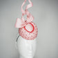 Cupids Bow - Baby pink Pork pie Pillbox with red veil and crystal detail and sculpted bow.