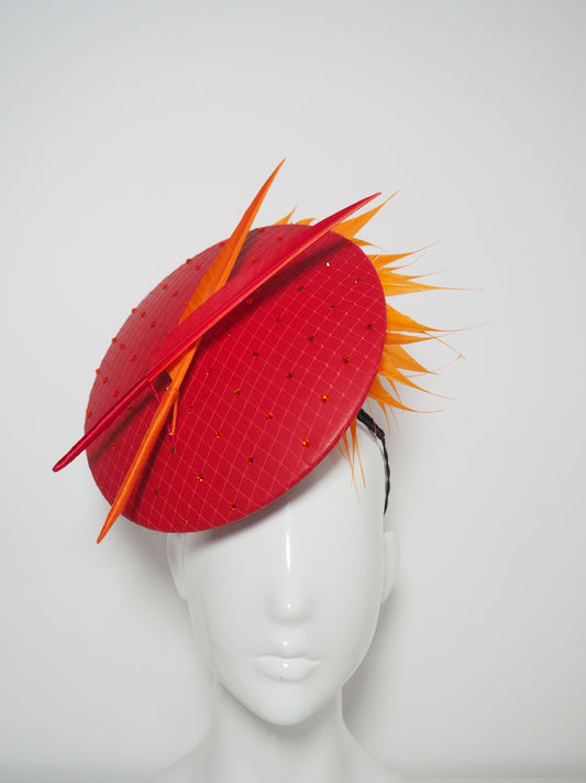 Out of the fire - Red leather percher disc with hyacinth orange diamantés trimmed quills and wired feather spray
