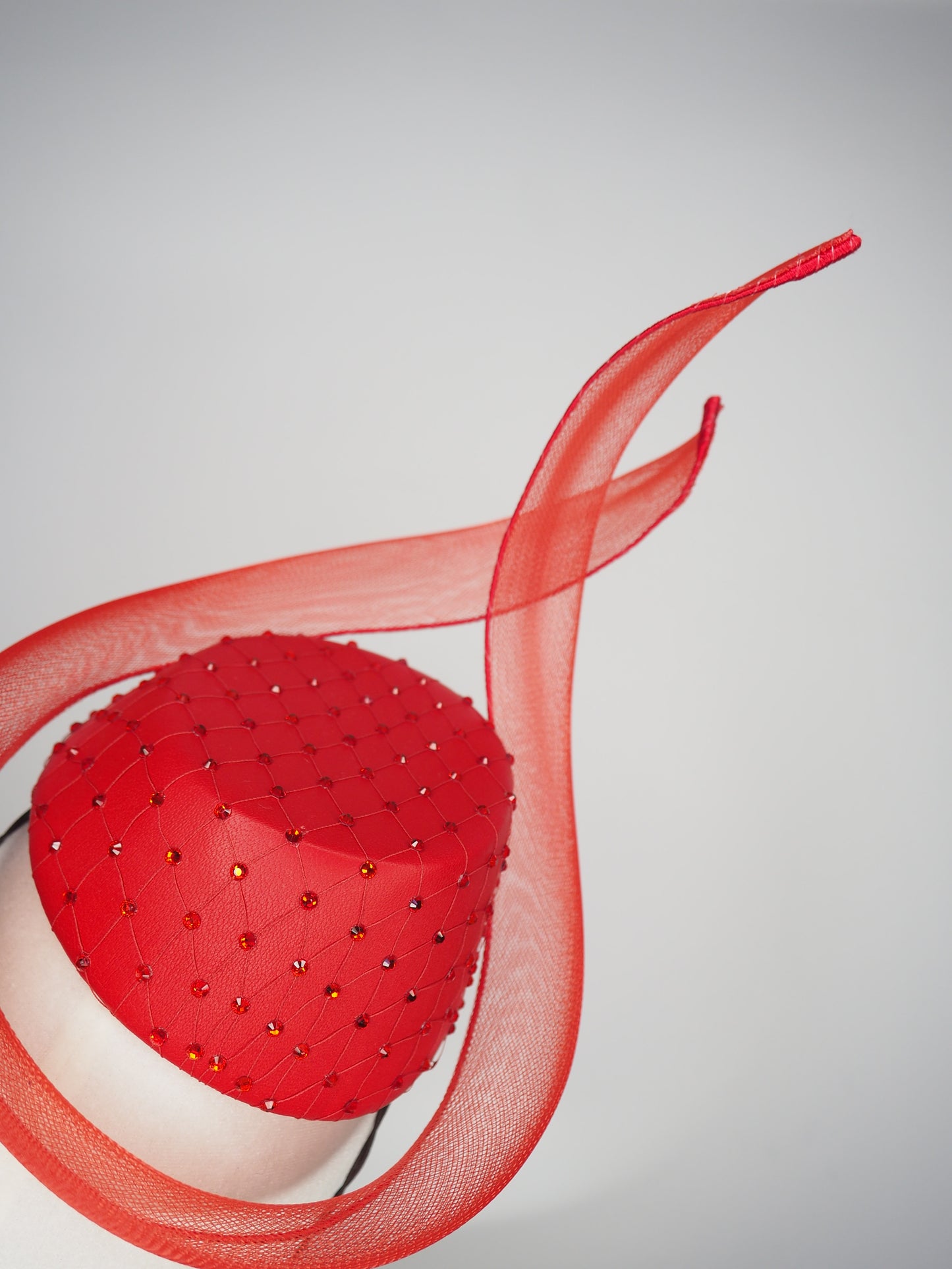 Ember - Red leather pillbox featuring a crystal-encrusted base and sculptural crinoline swirl.