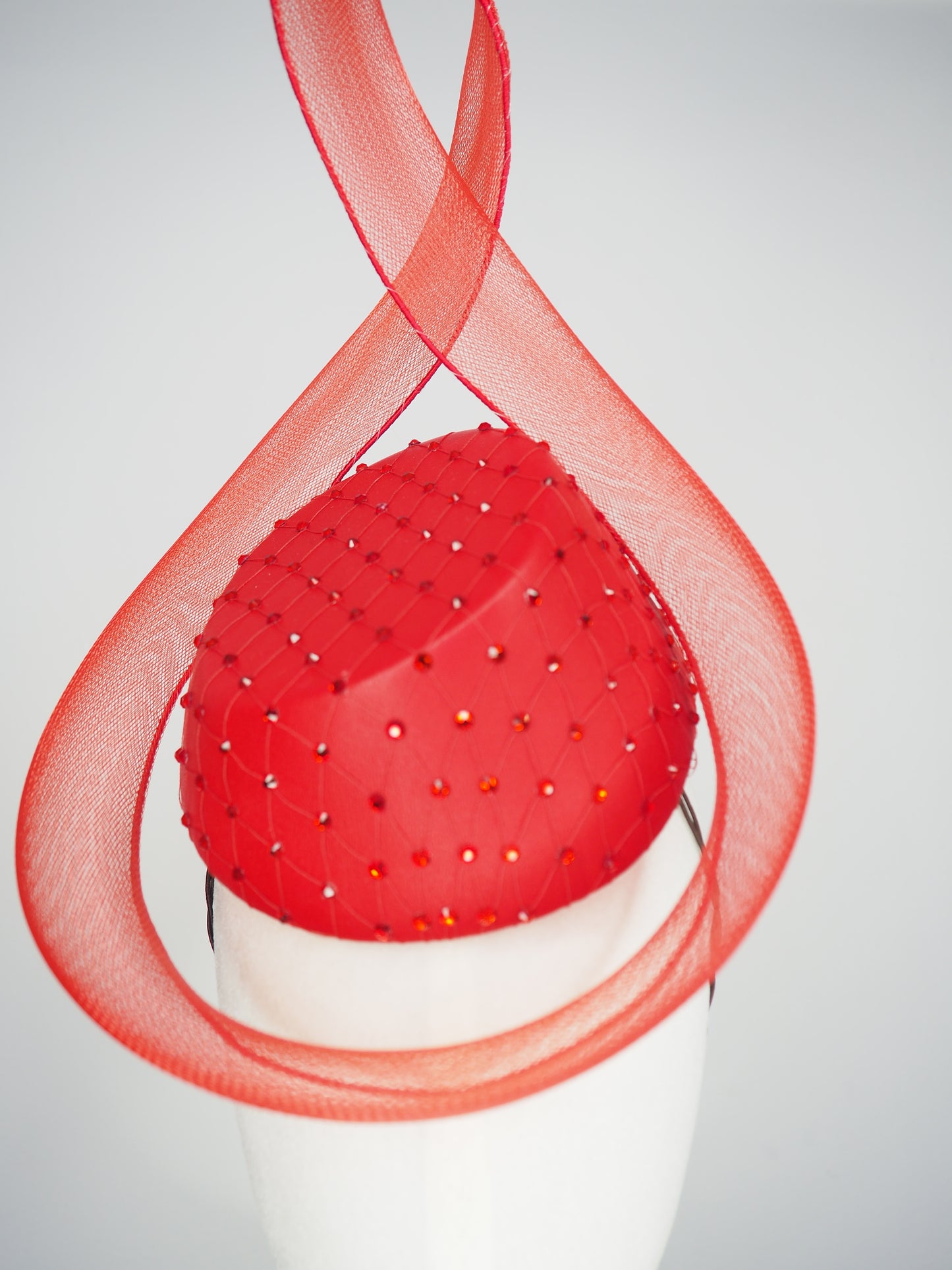 Ember - Red leather pillbox featuring a crystal-encrusted base and sculptural crinoline swirl.