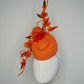 Clementine Twist - Orange pork pie pillbox with crystoform rose vine and tubular crinoline swirl