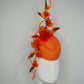 Clementine Twist - Orange pork pie pillbox with crystoform rose vine and tubular crinoline swirl