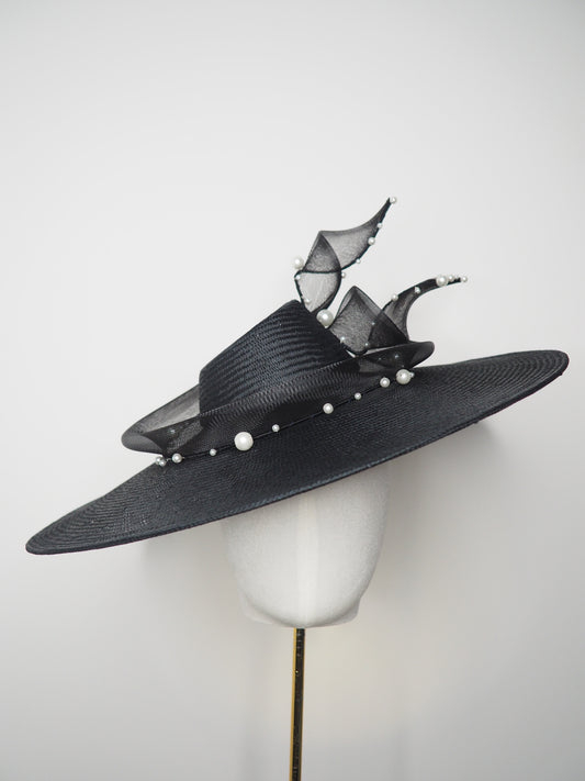 Pearl Noir - Black parasisal asymmetric crown slanted brim hat with sculptural crinoline swirl and pearl accents
