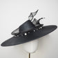 Pearl Noir - Black parasisal asymmetric crown slanted brim hat with sculptural crinoline swirl and pearl accents