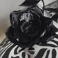 De Ville Rose - Sweeping crystoform wired brim with black rose petal pattern and single shiny dramatic rose with white leather veiled crown