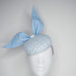 Blue pearl - Blue wired leather bow with pearl feature on a white and blue tweed button base with lurex flecks