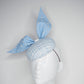Blue pearl - Blue wired leather bow with pearl feature on a white and blue tweed button base with lurex flecks