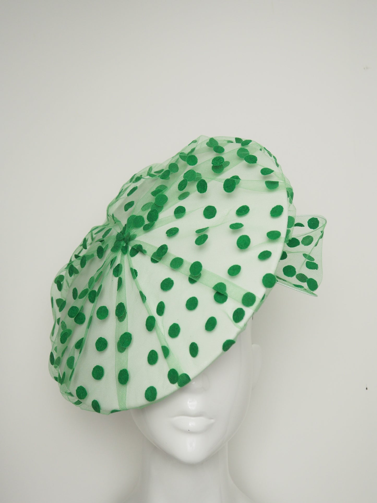 Spottie Dottie -White Leather Coolie brim with spotted green tulle overlay and wired bow.