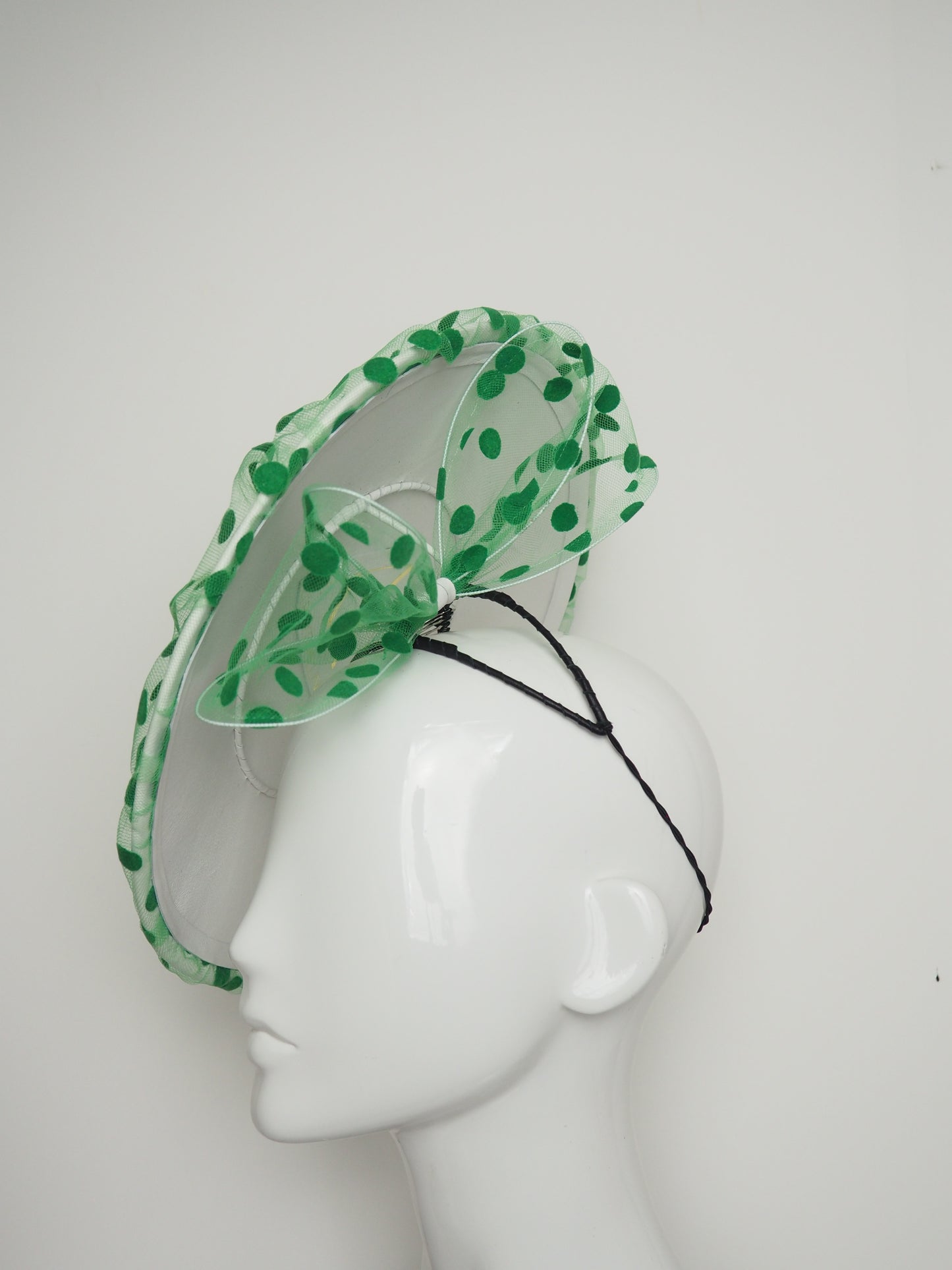 Spottie Dottie -White Leather Coolie brim with spotted green tulle overlay and wired bow.