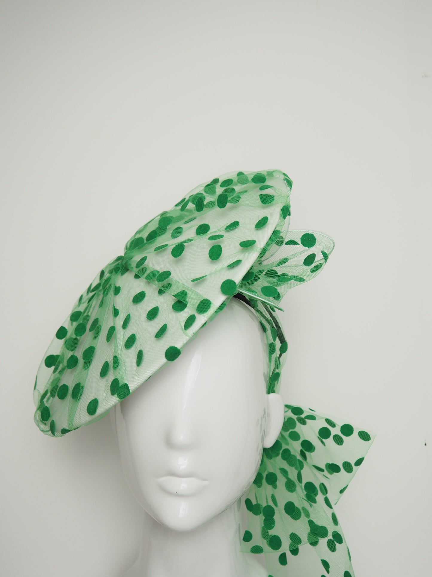 Spottie Dottie -White Leather Coolie brim with spotted green tulle overlay and wired bow.