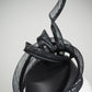 Serpentia - Black asymetrical leather sharp pillbox with crinoline swirl knot