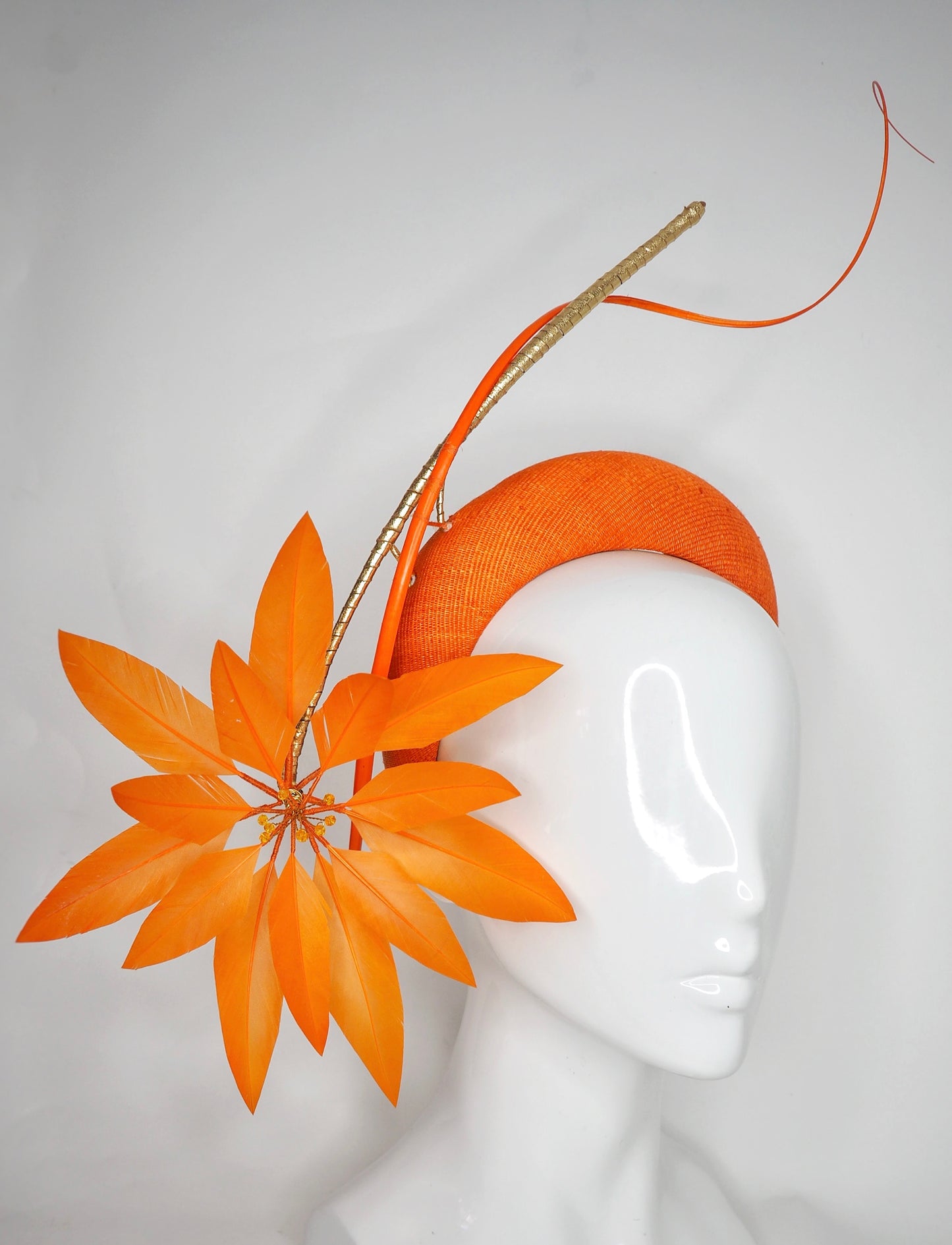 Fireworks - Orange straw base with sculpted quills and leather starburst.