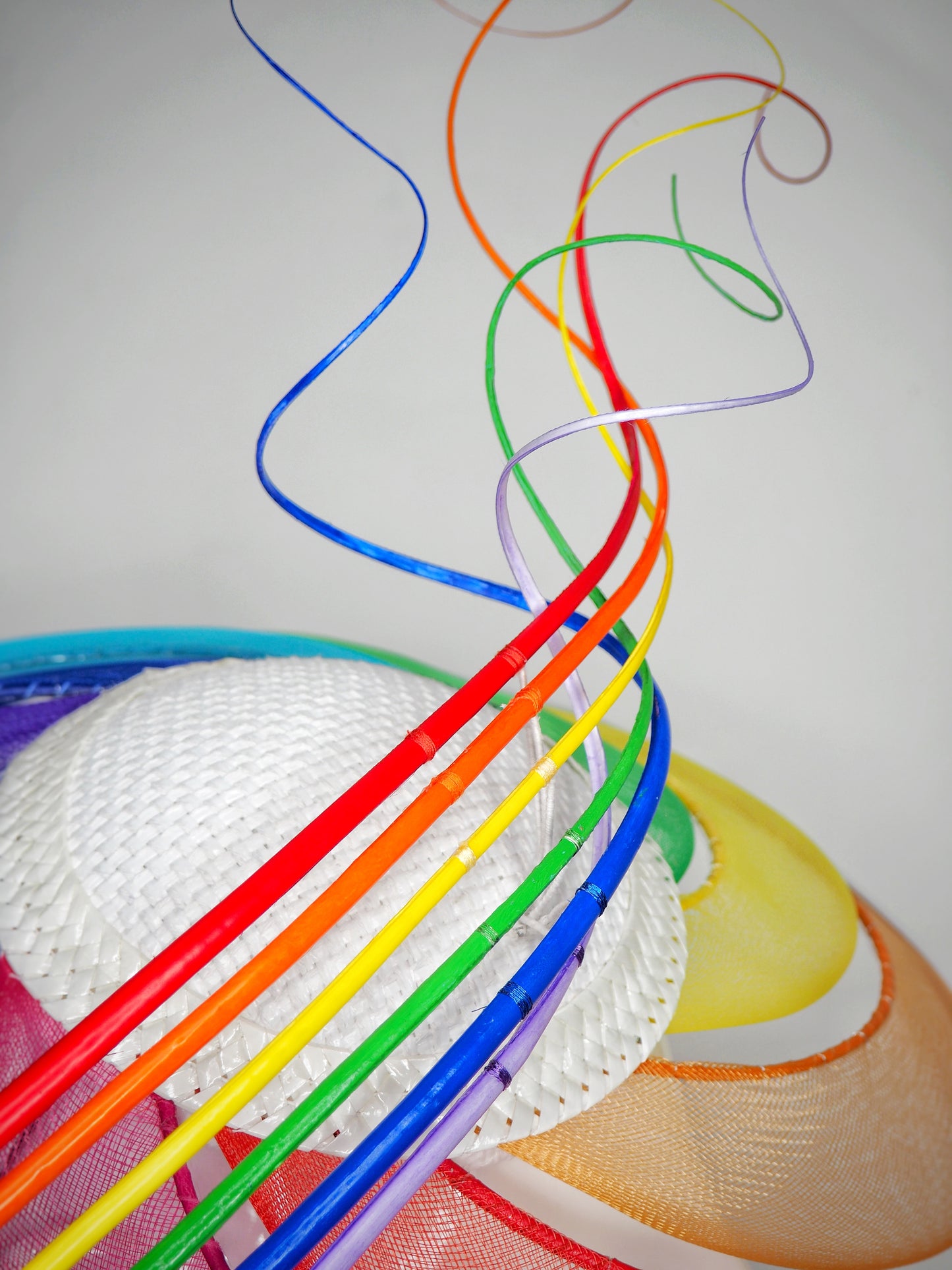 Over The Rainbow - Rainbow crinoline wired brim with textured white crown and rainbow quills.