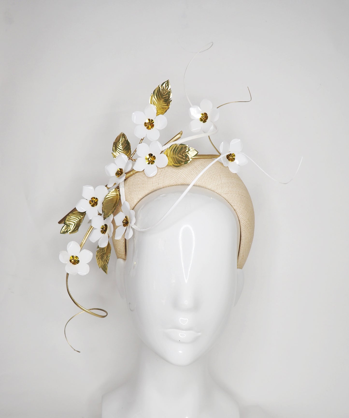 Blossom - White cherry blossoms on a natural straw 3D base with gold and white quills.
